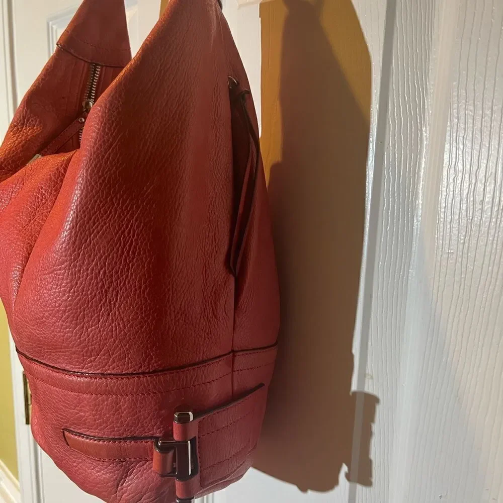B Makowsky leather orange Hobo bucket style shoulder bag  silver tone hardwares